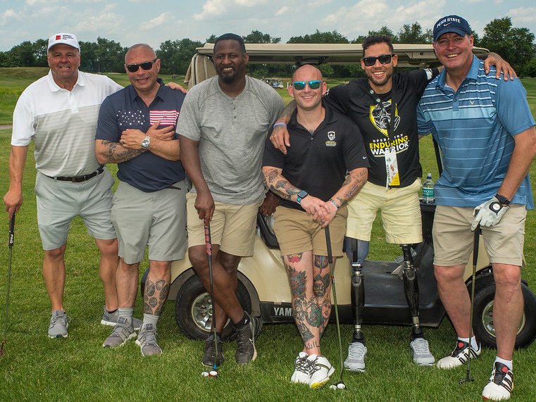 Scott Payne with OEW veteran and group at JYP Celebrity Golf