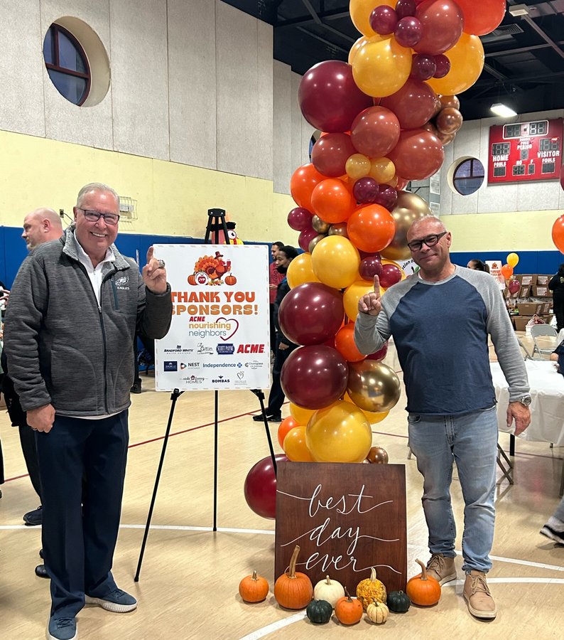Ron Jaworski and Scott Payne at Turkey Drive sponsor board