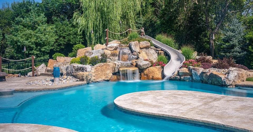 Freeform lagoon pool with rope bridge in Hillsborough NJ